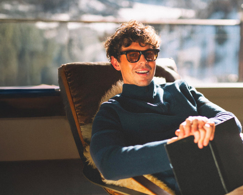Man sitting in a chair with a scenic background