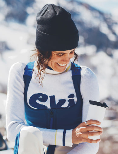 Person in ski gear standing in a snowy mountain landscape