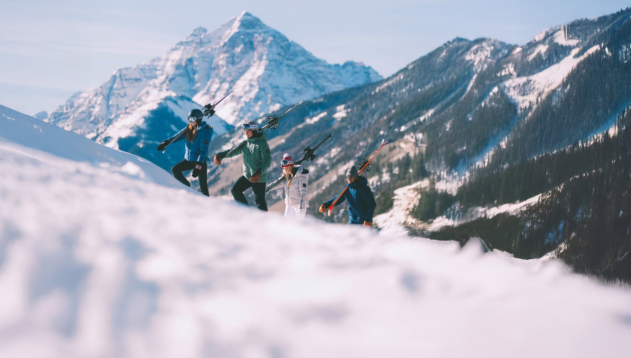 People skiing with a mountainous landscape in the background
