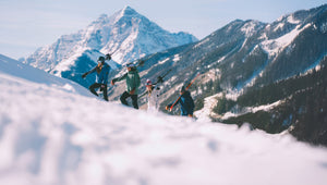 People skiing with a mountainous landscape in the background