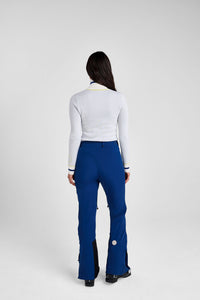 Person wearing a white top and blue pants on a white background