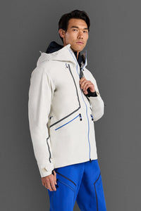 Person wearing a white jacket with blue accents on a gray background