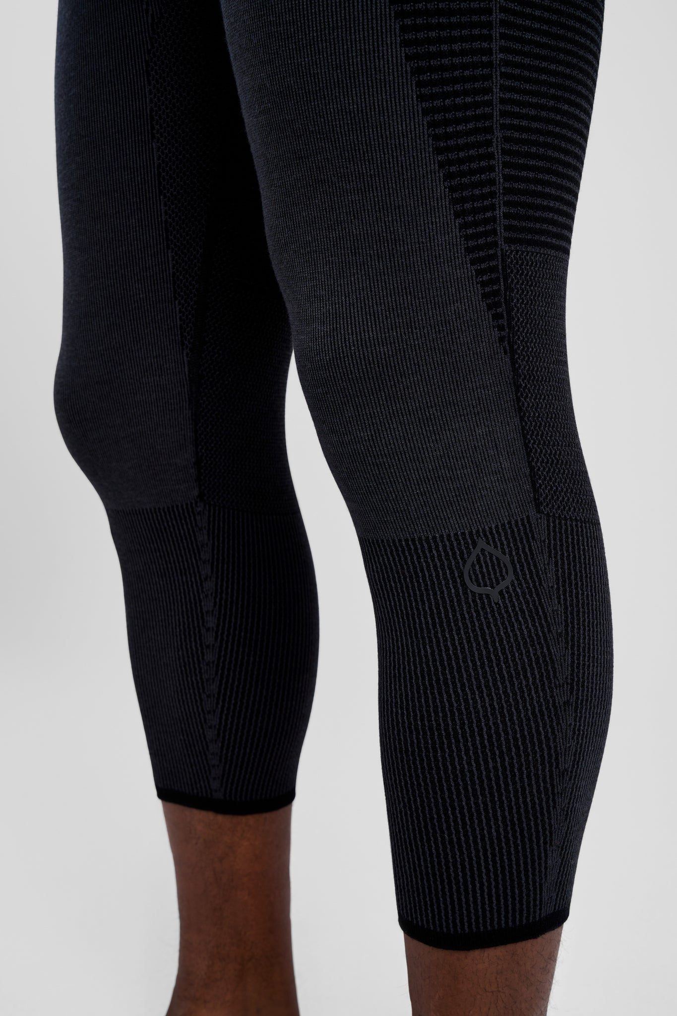 Black leggings with textured pattern on a white background
