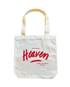 Whit canvas over the should tote with red words "Alex Israel's Heaven, Aspen Colorado, words have a easy, fun cursive style font