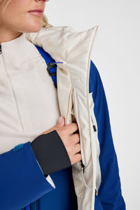 Close-up of a person wearing a blue and white jacket with a hood.
