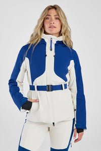 Woman wearing a blue and white ski suit on a gray background