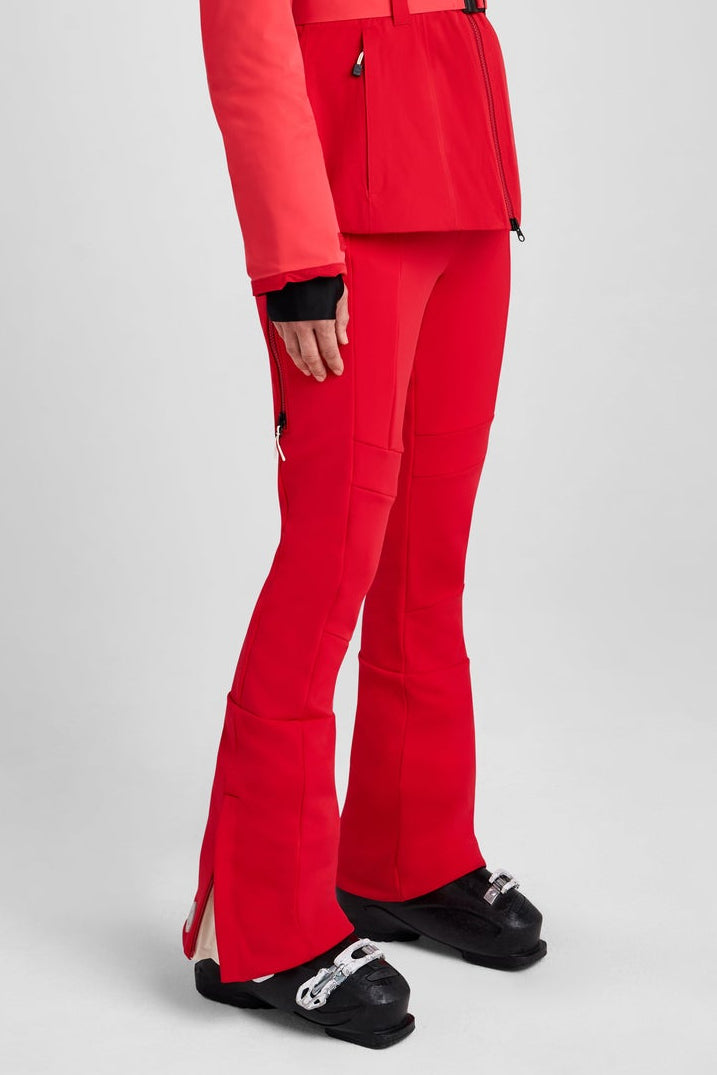 Person wearing a red ski suit and helmet on a gray background