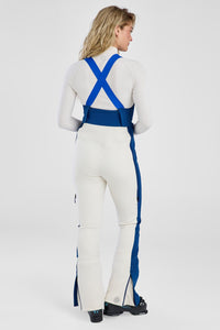 Person wearing a white and blue jumpsuit on a plain background