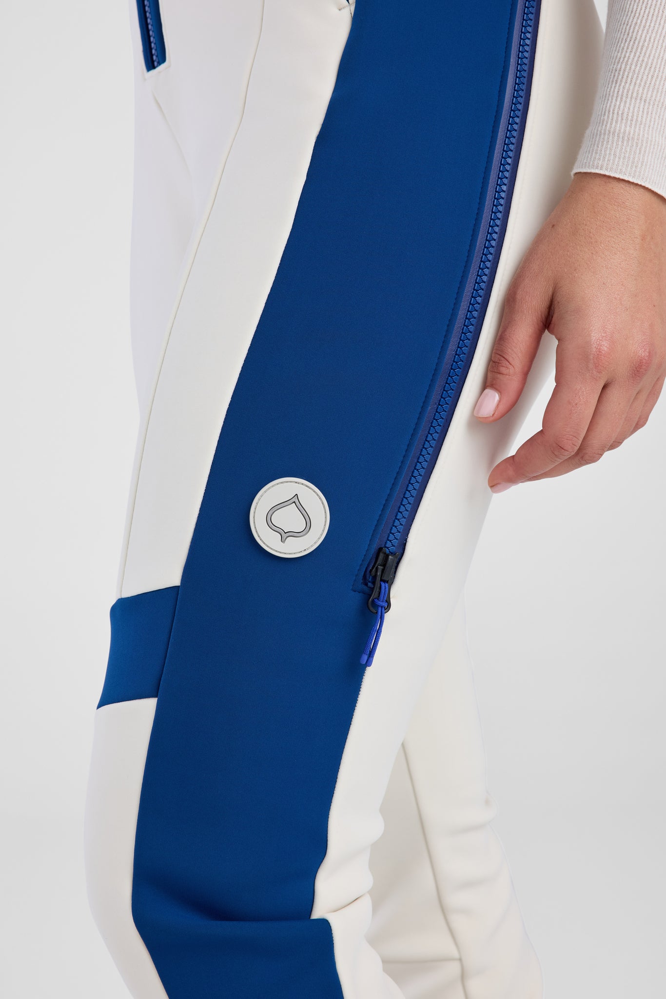 Close-up of a white and blue jacket with a brand logo on a white background