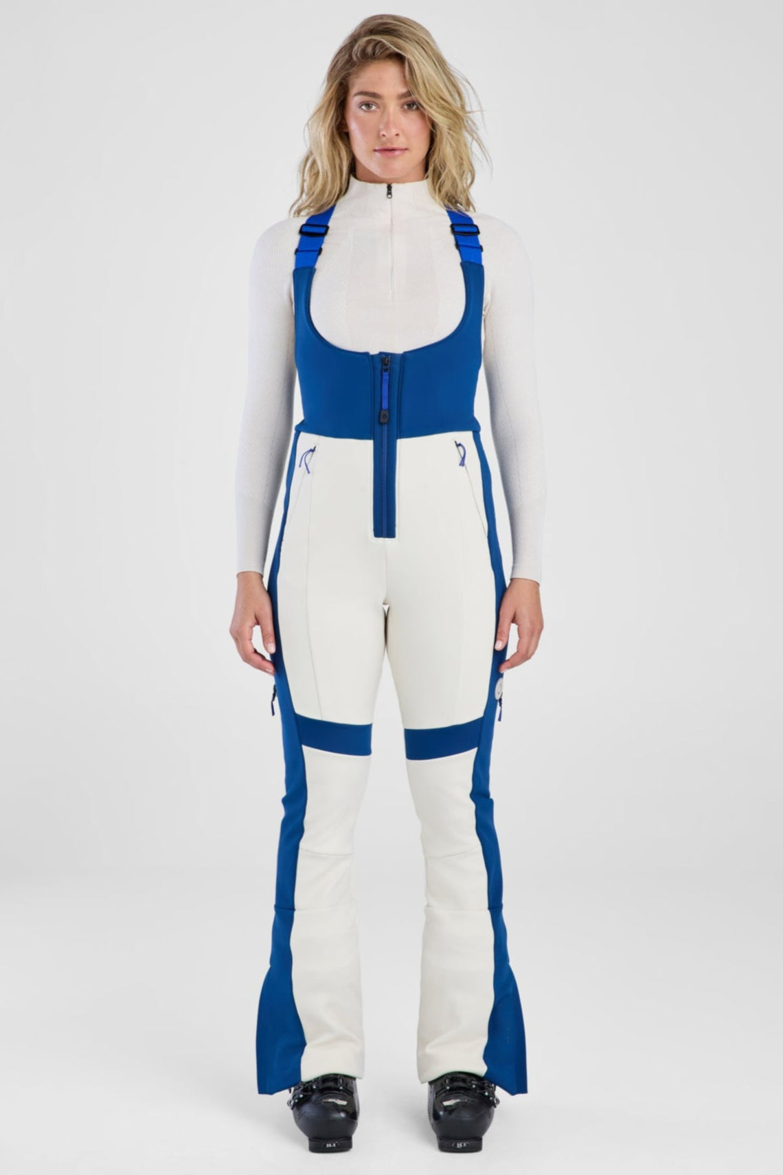 Person wearing a white and blue jumpsuit on a white background
