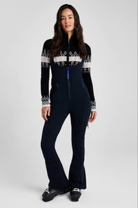 Woman wearing a black ski suit with white patterns on a white background