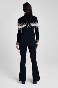 Person wearing a black outfit with white patterns on a white background