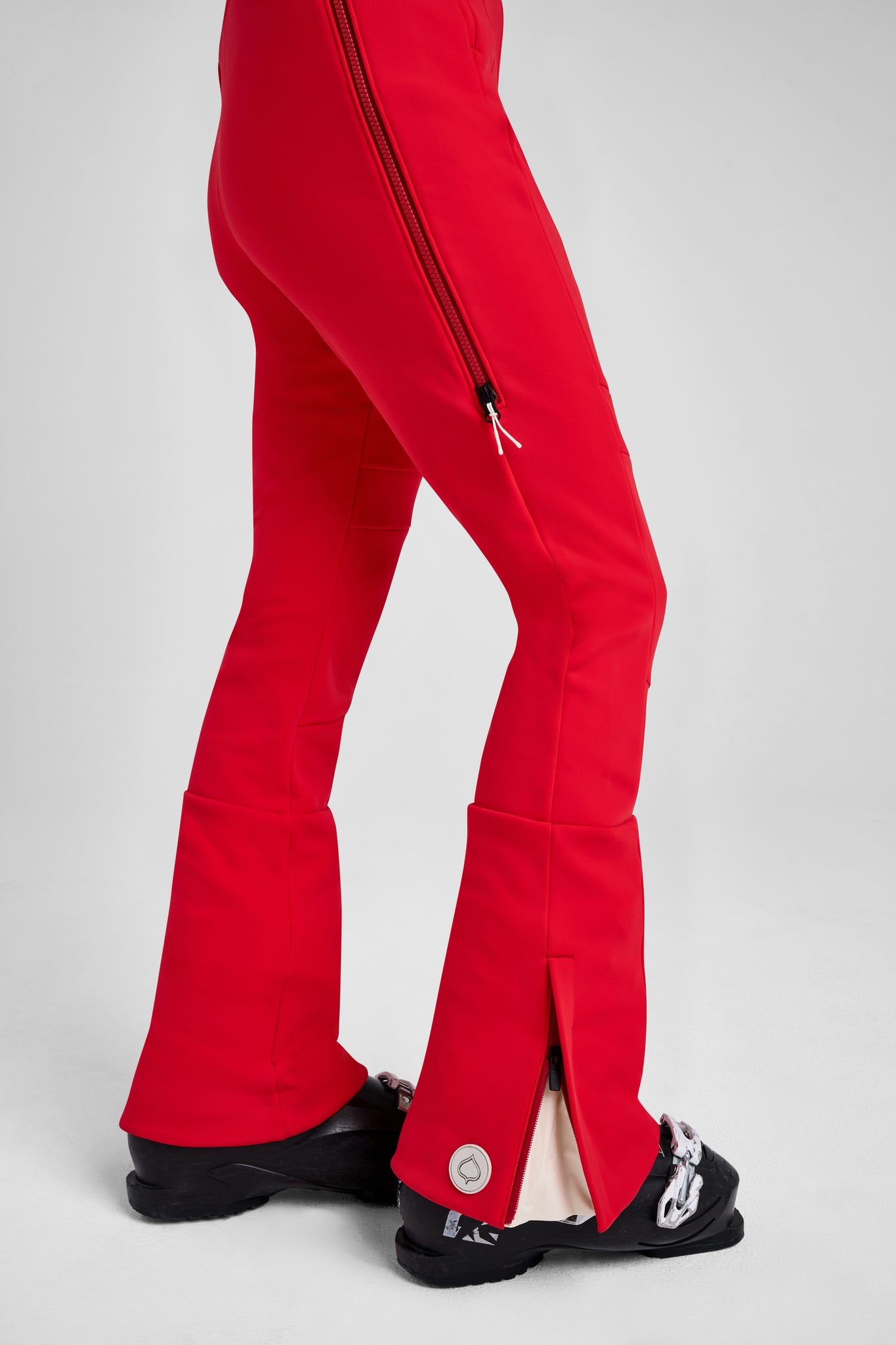 Red pants with a zipper detail on a white background