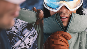 A person zips up a green jacket with a patterned interior as snowflakes fall.