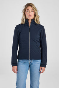 Woman wearing a black jacket and light blue jeans on a white background