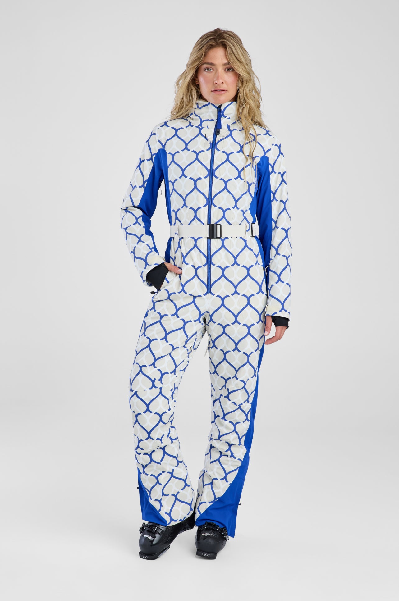 Person wearing a blue and white patterned snowsuit on a white background