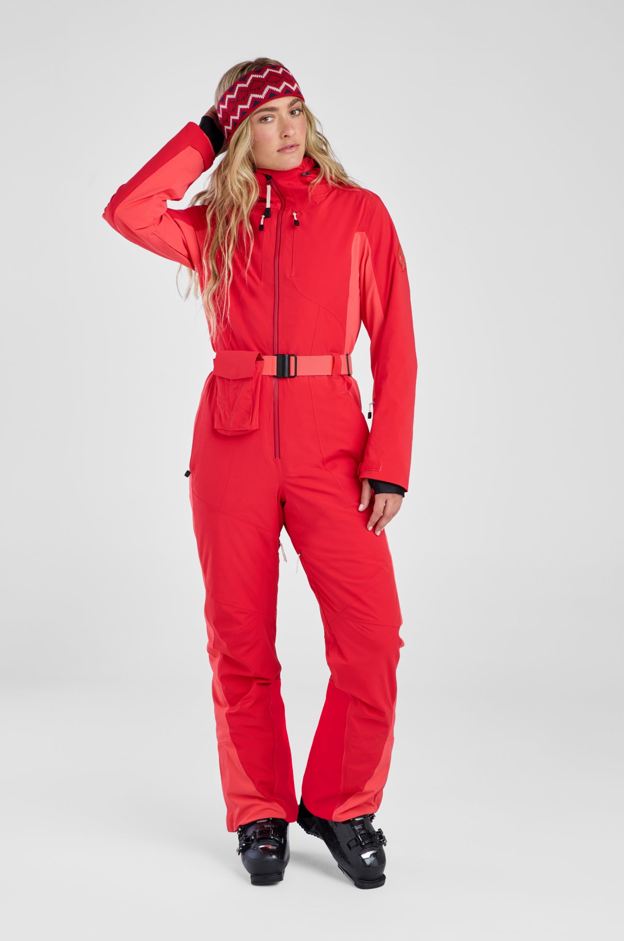 Person wearing a red ski suit on a white background