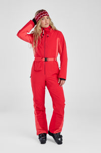 Person wearing a red ski suit on a white background