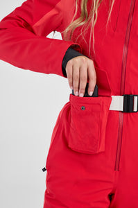 Person wearing a red snowsuit with a white background