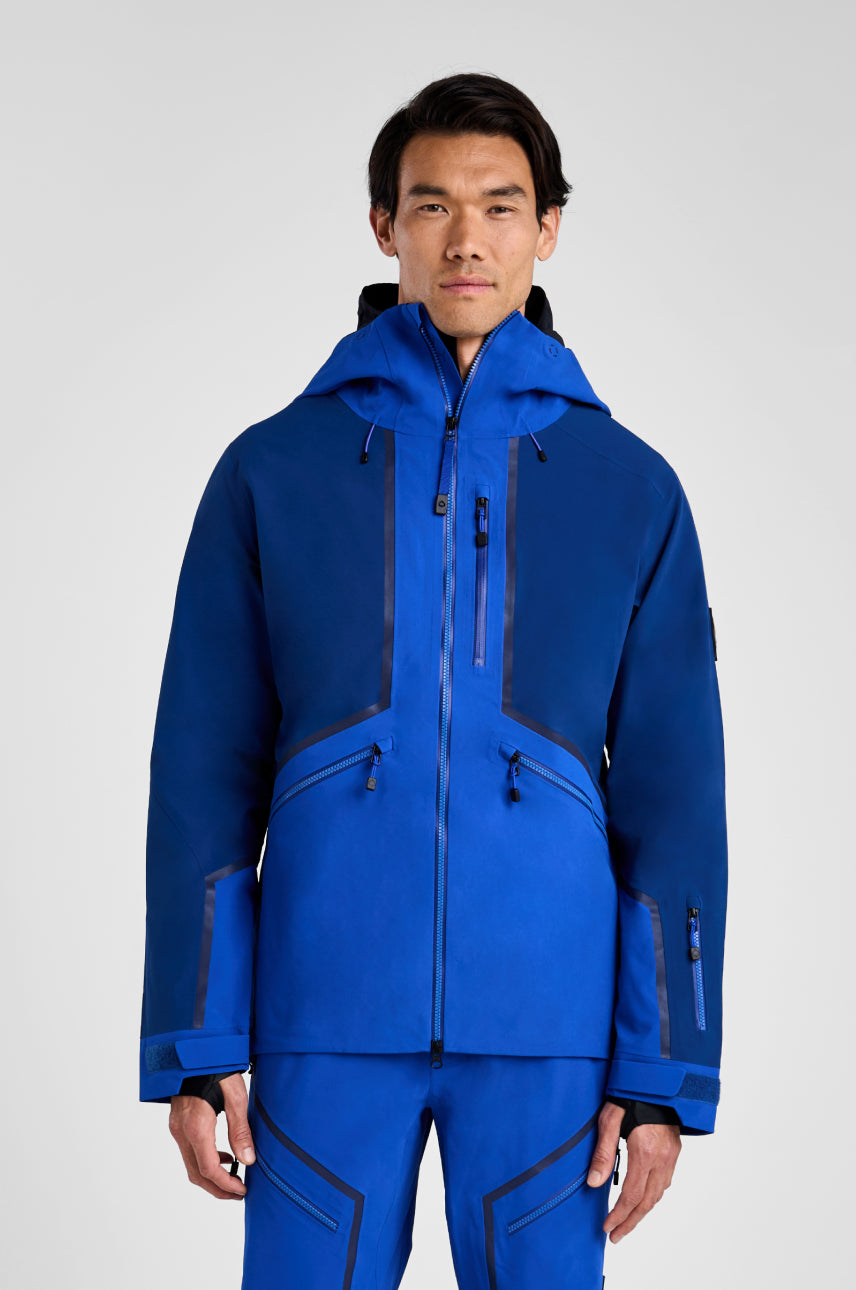 Person wearing a blue jacket and pants on a white background