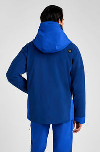 Person wearing a blue jacket and pants on a white background