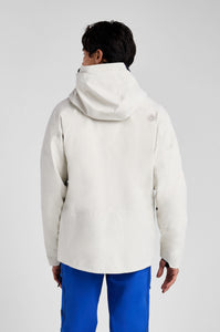 Person wearing a white jacket with a hood on a light gray background