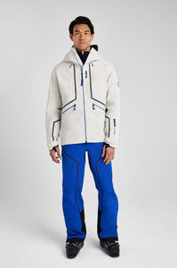 Person wearing a white ski jacket and blue pants on a gray background