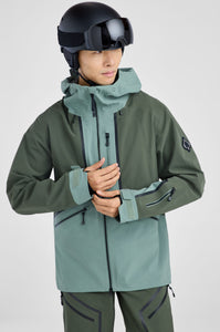 Person wearing a green ski jacket and helmet on a light gray background