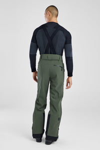Person wearing a black top and green pants on a white background