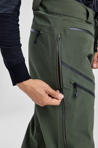 Green pants with zippers and pockets on a light gray background