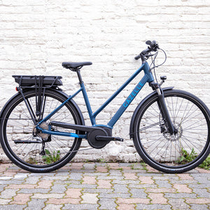 Blue Gazelle electric road bike, in front of white wall, a rentable option by aspen collection