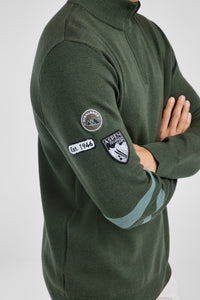 Green sweater with patches on a white background