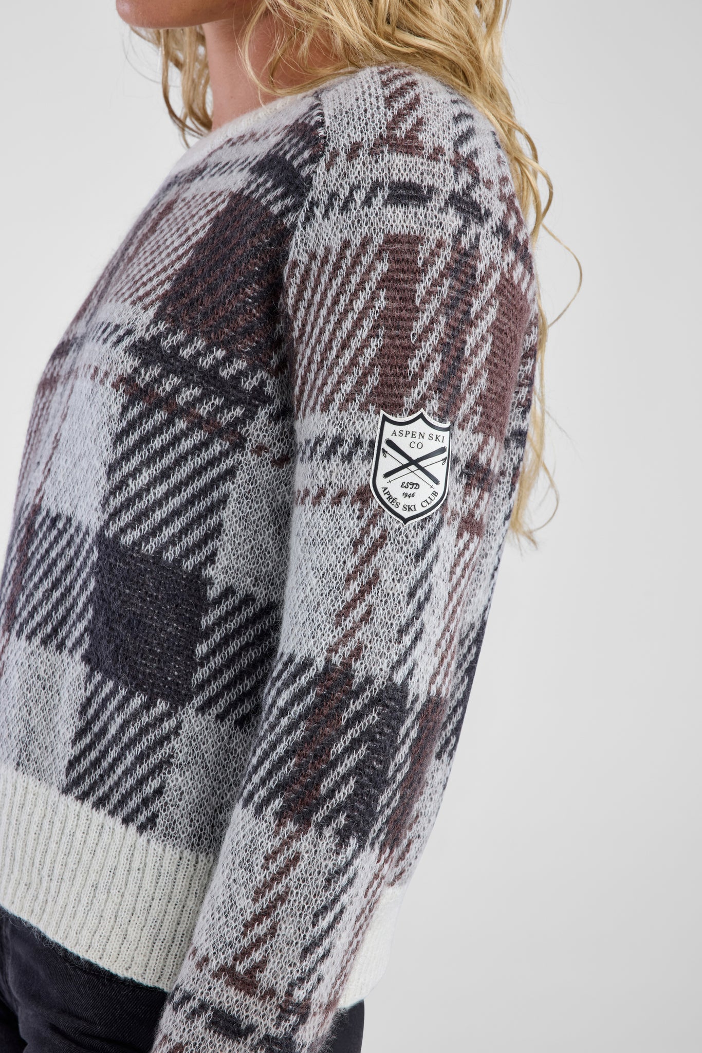 Plaid sweater with a patch on a white background