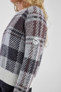 Plaid sweater with a patch on a white background