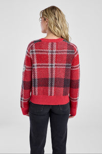 Person wearing a red plaid sweater on a plain background