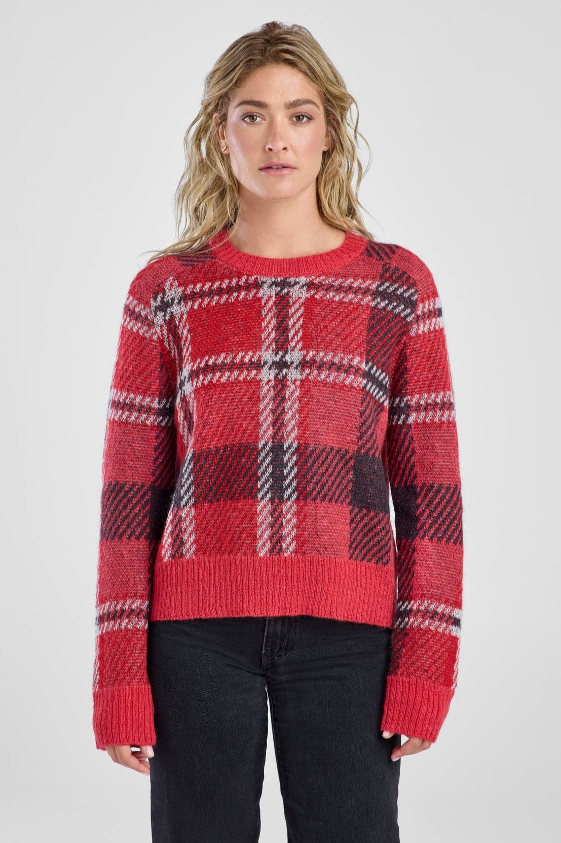 Woman wearing a red plaid sweater on a white background
