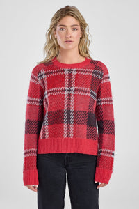 Woman wearing a red plaid sweater on a white background