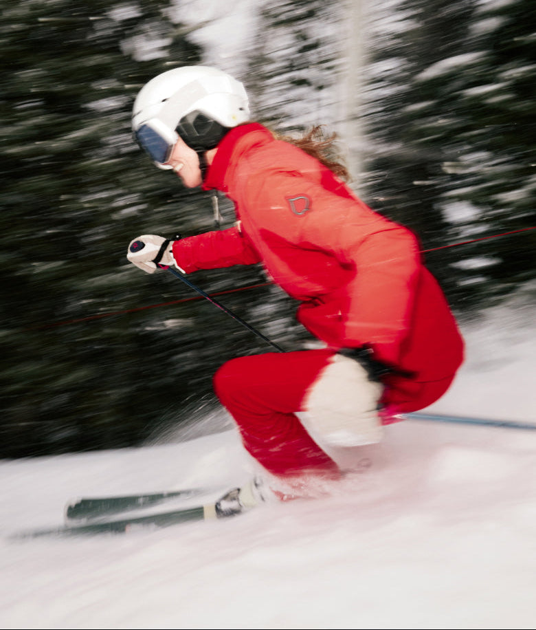 Person skiing in a snowy landscape with trees