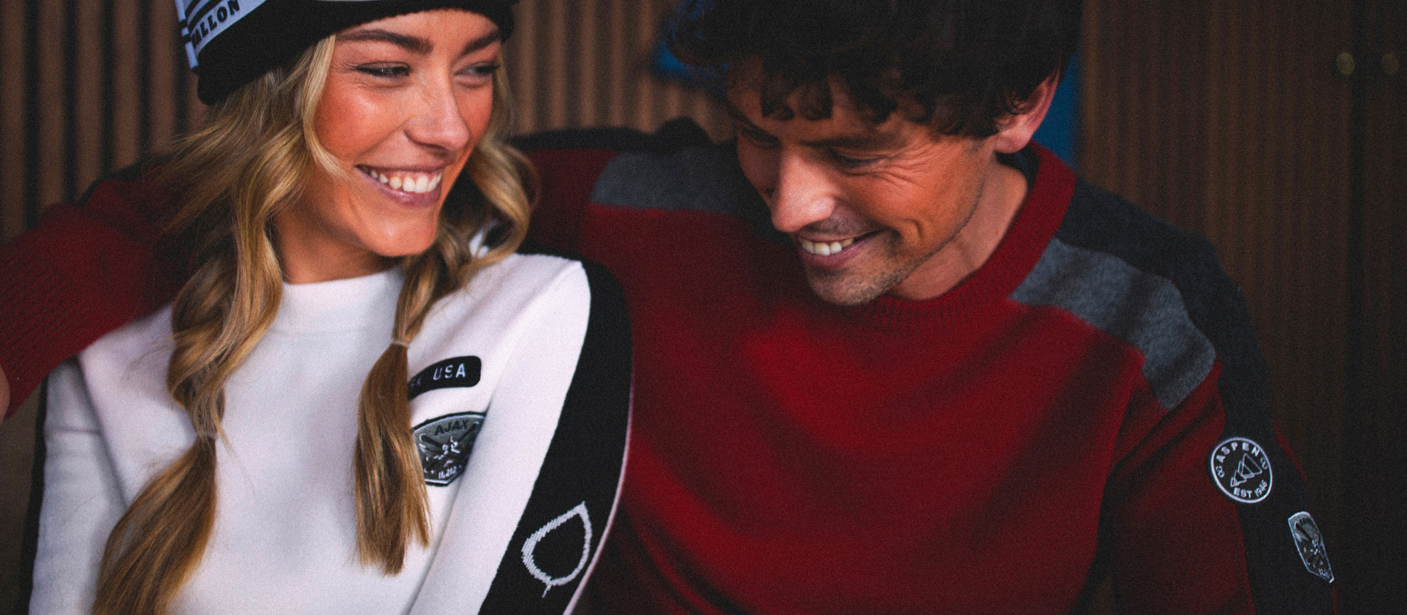 Two people wearing branded jackets in a casual setting
