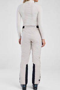 Person wearing a white ski suit with black accents on a white background