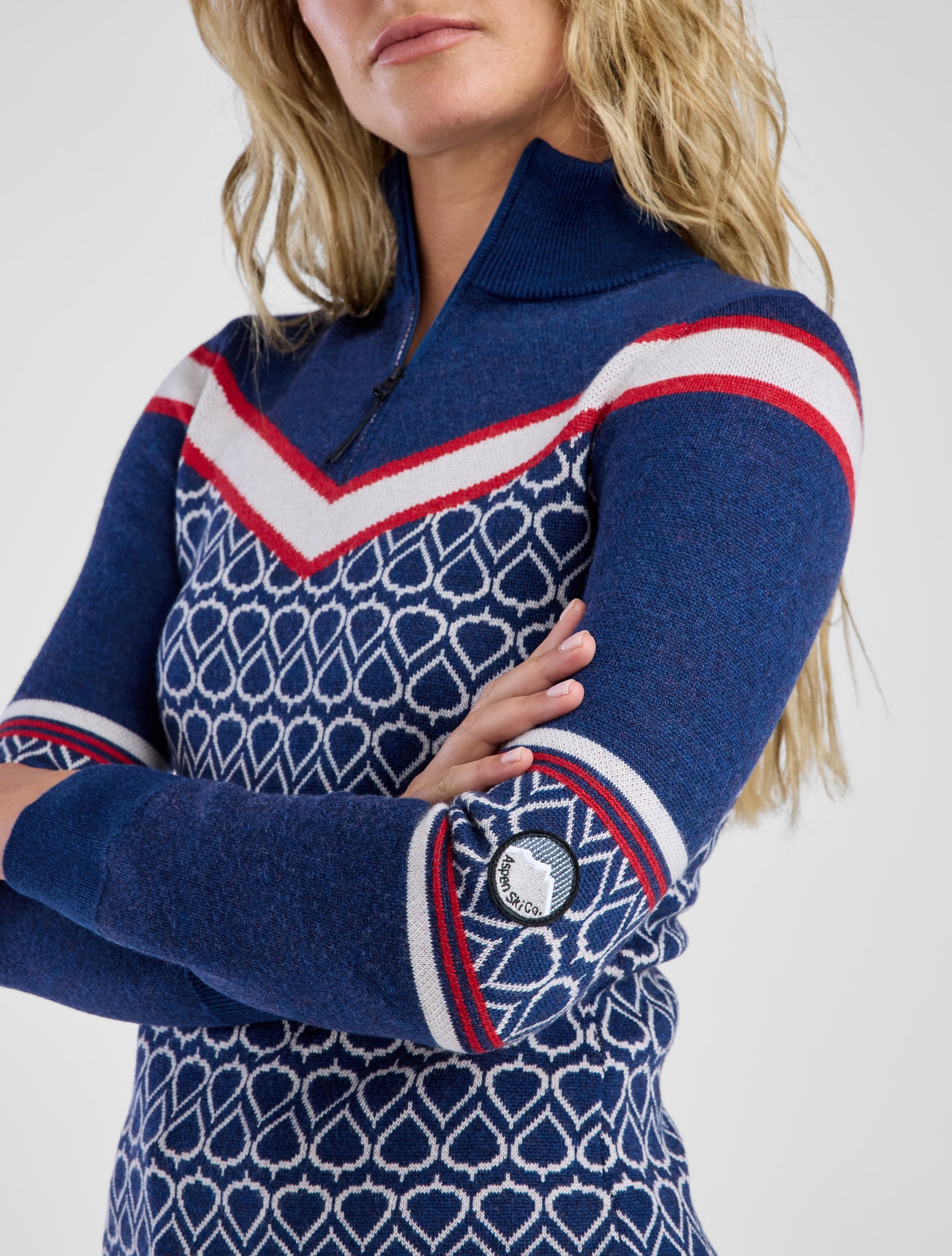 Women in navy and red patterned sweater