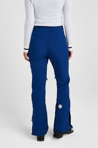 Person wearing blue pants and a white top on a light gray background