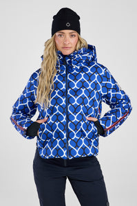 Woman wearing a blue patterned jacket with a white background