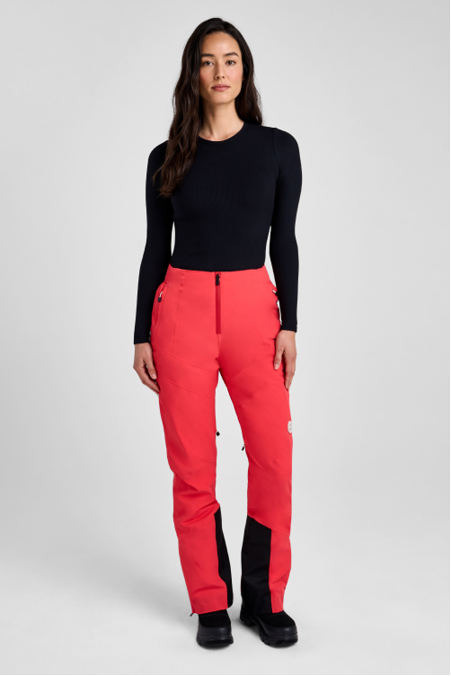 Person wearing red pants and black top on a white background